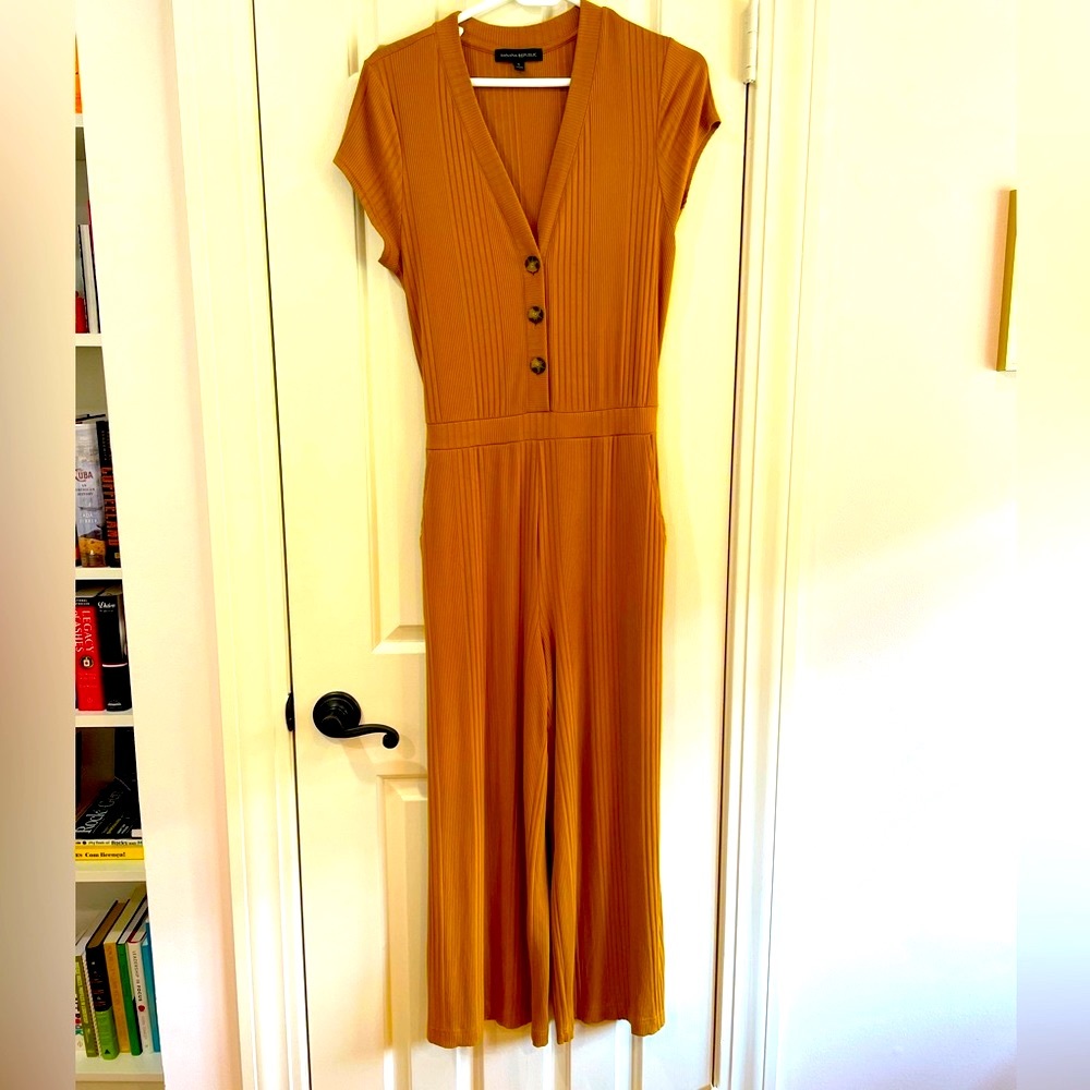 Mustard yellow, jump suit, with pockets.